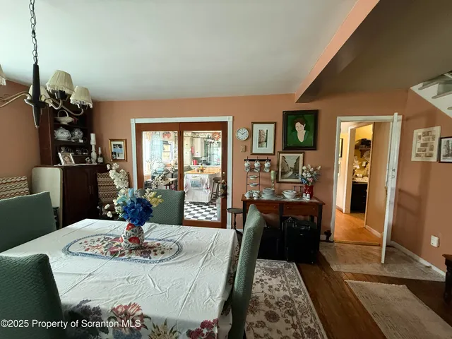 a dining room with furniture and wooden floor