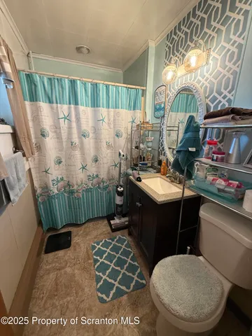 a bathroom with a sink mirror vanity and toilet