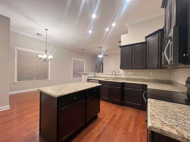 1977 Rochelle Lane Cordova, TN 38016 - Photo 11 of 26 a kitchen with granite countertop kitchen island stainless steel appliances and wooden cabinets