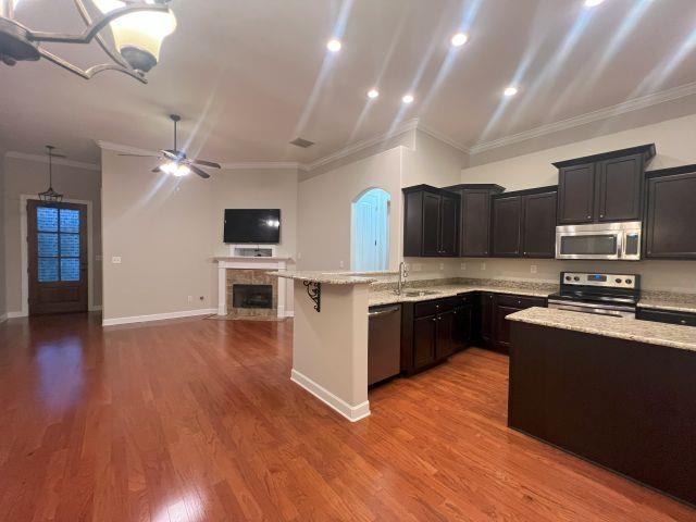 1977 Rochelle Lane Cordova, TN 38016 - Photo 26 of 26 a kitchen with stainless steel appliances kitchen island granite countertop a stove top oven a sink with wooden floors