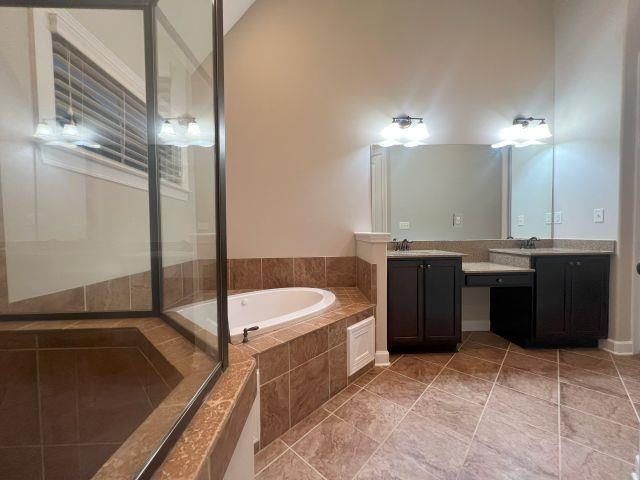 1977 Rochelle Lane Cordova, TN 38016 - Photo 13 of 26 a spacious bathroom with a bathtub sink and mirror