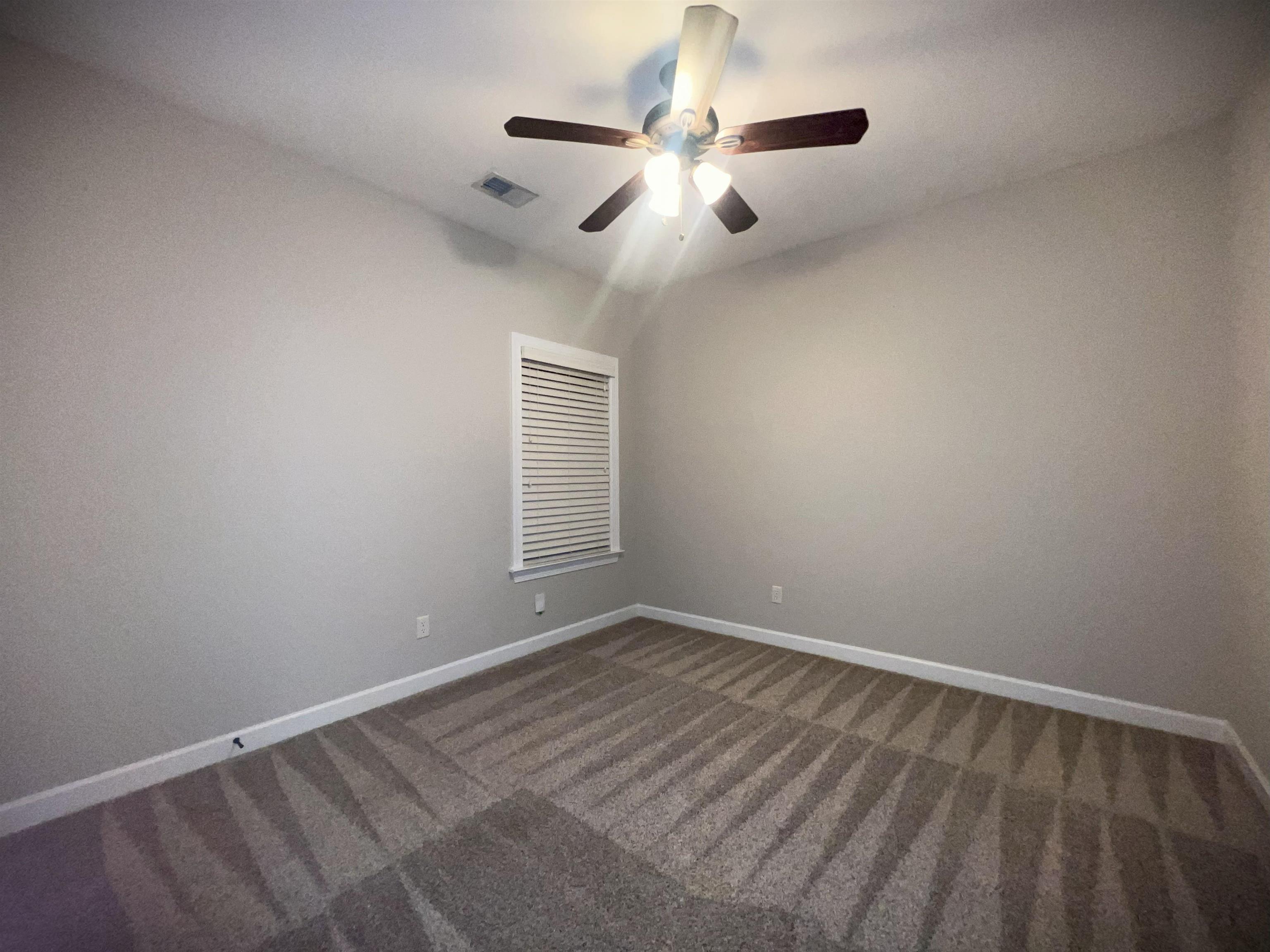 1977 Rochelle Lane Cordova, TN 38016 - Photo 15 of 26 an empty room with chandelier fan and windows