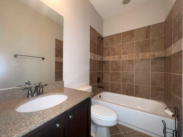1977 Rochelle Lane Cordova, TN 38016 - Photo 16 of 26 a bathroom with a granite countertop bathtub sink vanity mirror and toilet