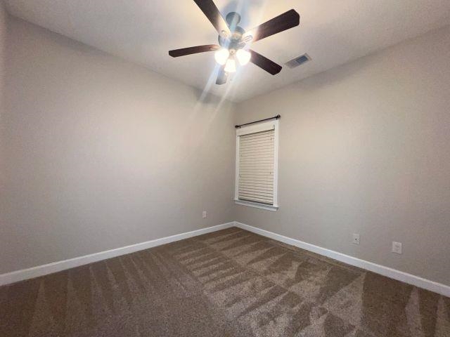 1977 Rochelle Lane Cordova, TN 38016 - Photo 17 of 26 an empty room with a chandelier fan and windows