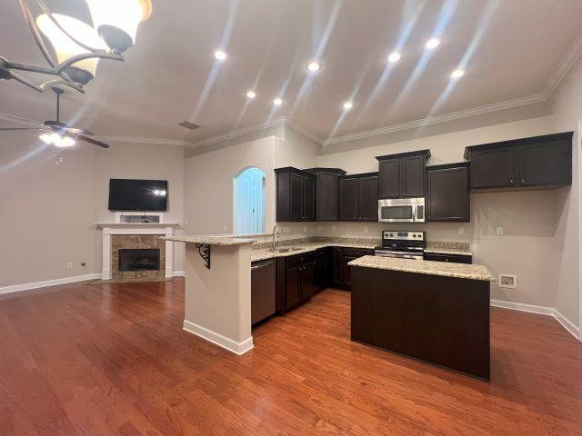 1977 Rochelle Lane Cordova, TN 38016 - Photo 25 of 26 a large kitchen with stainless steel appliances granite countertop a stove and a microwave