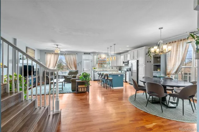 a dining room with furniture wooden floor and a rug
