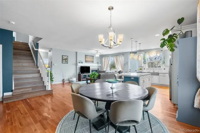 a view of a dining room with furniture wooden floor and chandelier