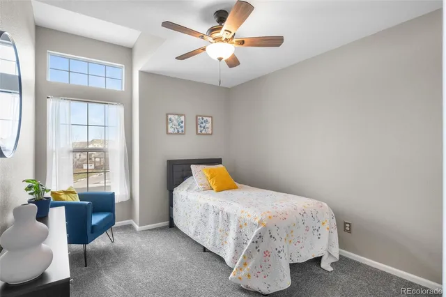 a bedroom with a bed and ceiling fan