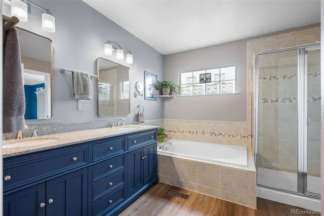 a bathroom with a bathtub shower and double vanity sink