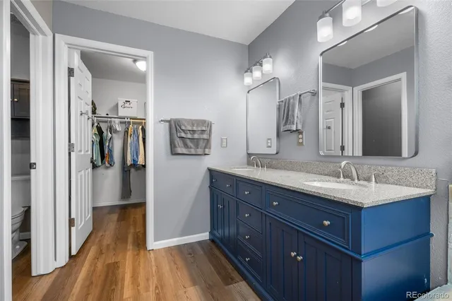 a spacious bathroom with a double vanity sink and a mirror