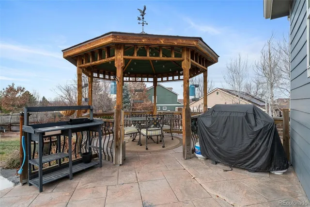 a view of a chairs and table in the back yard of the house