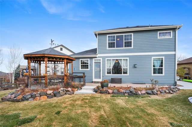 a front view of a house with swimming pool and furniture