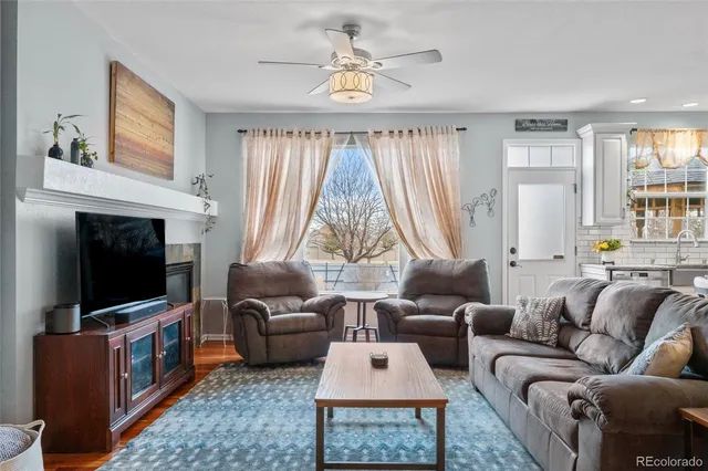 a living room with furniture a fireplace and a flat screen tv