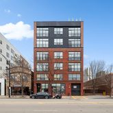 a front view of a building with a yard