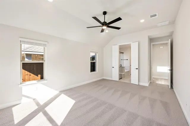 an empty room with closet and windows