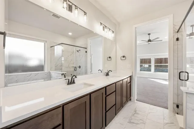 a bathroom with a double vanity sink a mirror and a bathtub