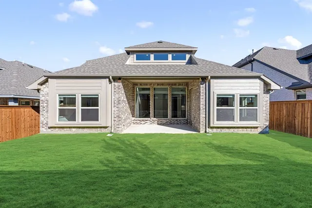 a front view of a house with yard and green space