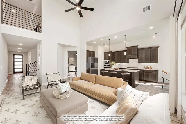a living room with furniture and view of kitchen