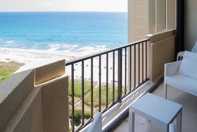 a view of a balcony with ocean view
