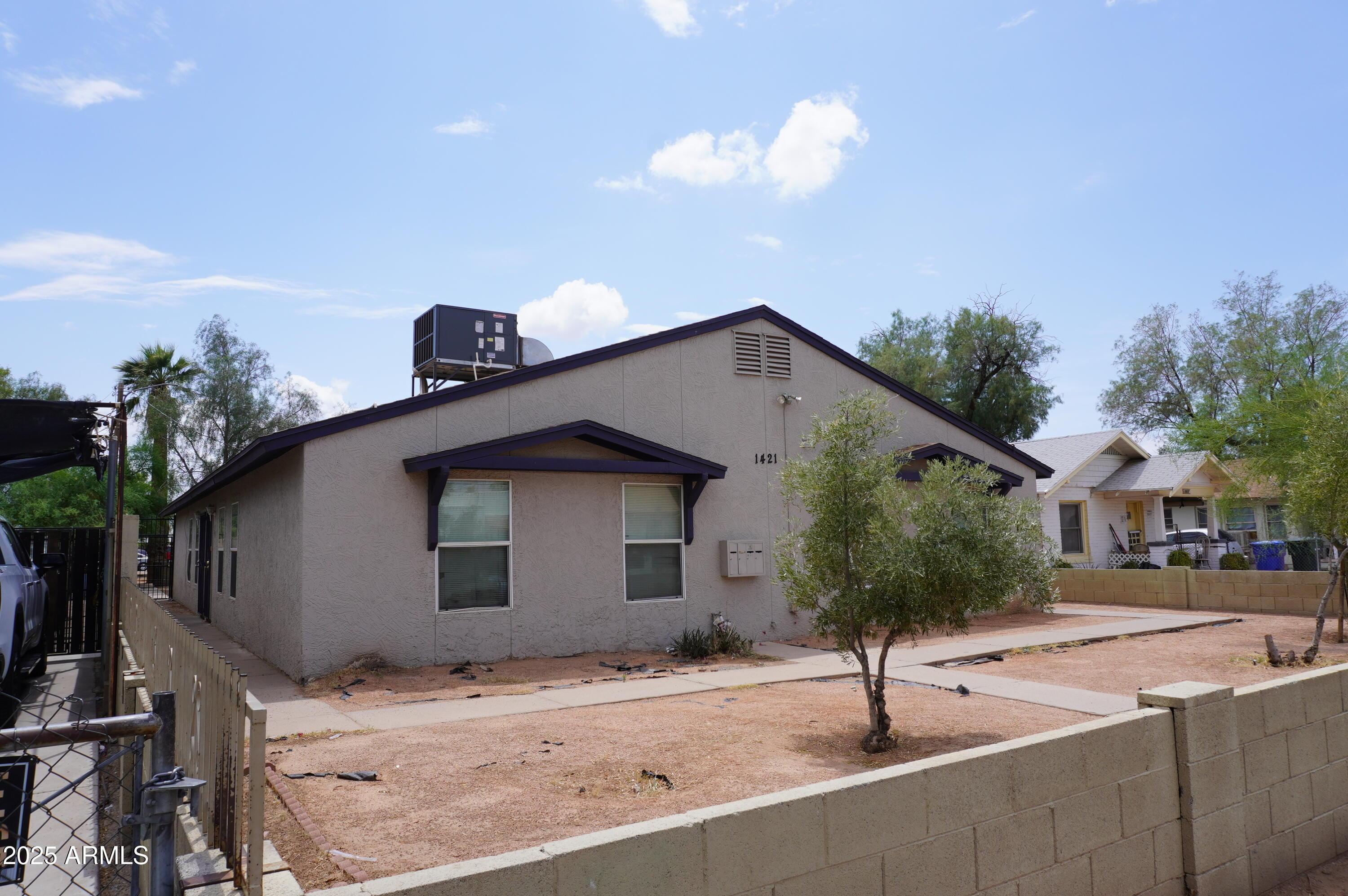 1421 East Fillmore Street, Unit 4 Phoenix, AZ 85006 - Photo 1 of 18 a house with street view