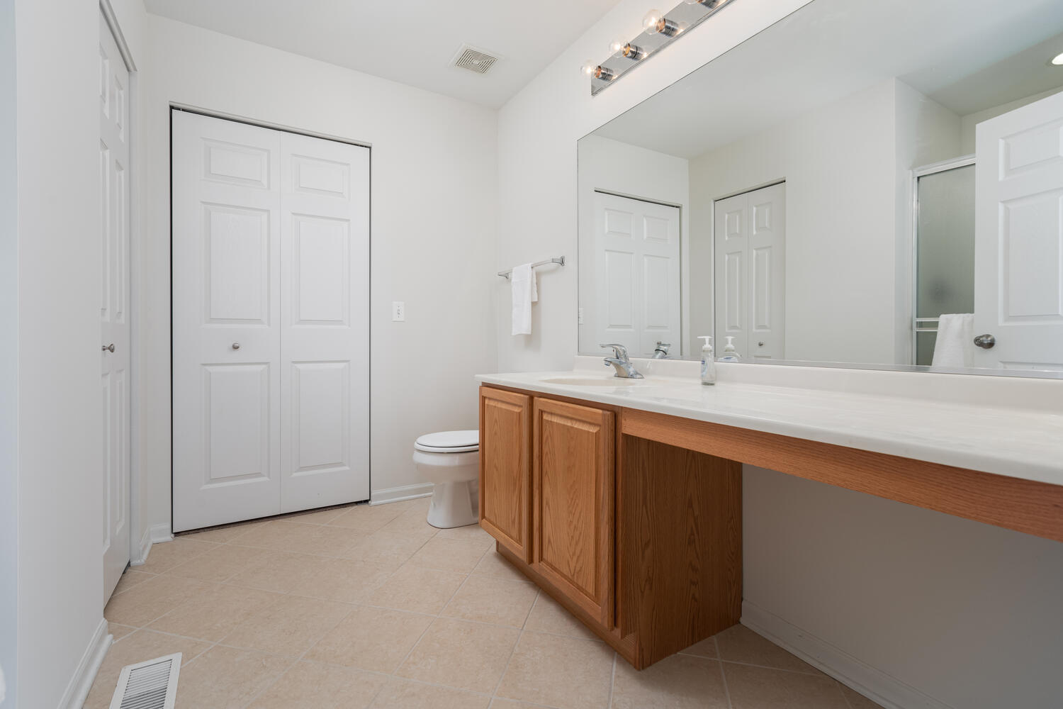 31 Rolling Oaks Road, Unit A Sugar Grove, IL 60554 - Photo 17 of 25 a spacious bathroom with a double vanity sink toilet and mirror