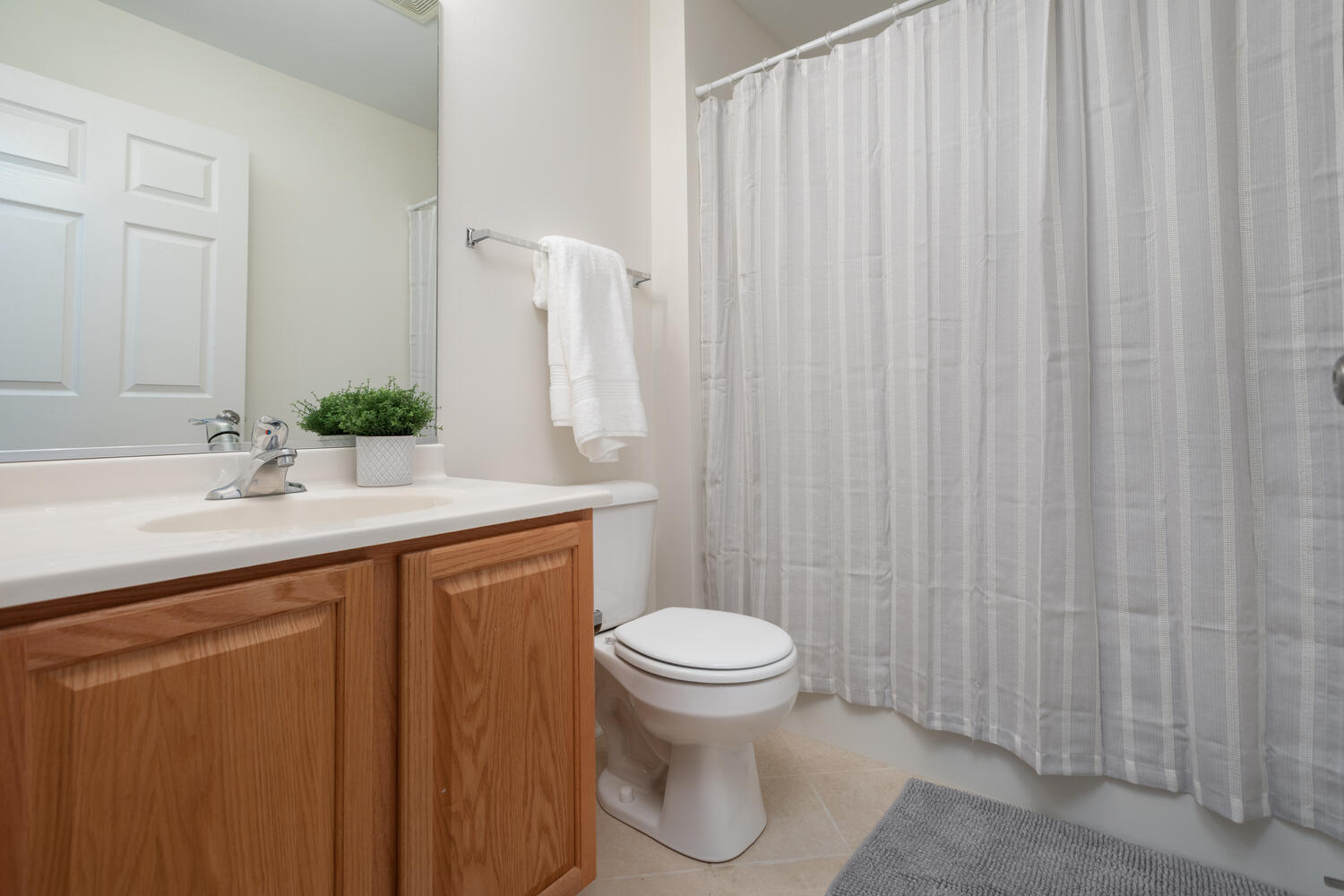 31 Rolling Oaks Road, Unit A Sugar Grove, IL 60554 - Photo 21 of 25 a bathroom with a sink a toilet and shower curtain