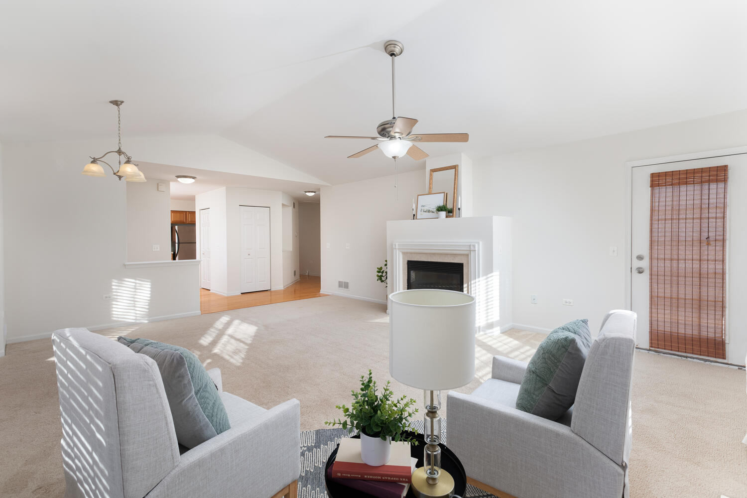 31 Rolling Oaks Road, Unit A Sugar Grove, IL 60554 - Photo 7 of 25 a living room with furniture a fireplace and a chandelier