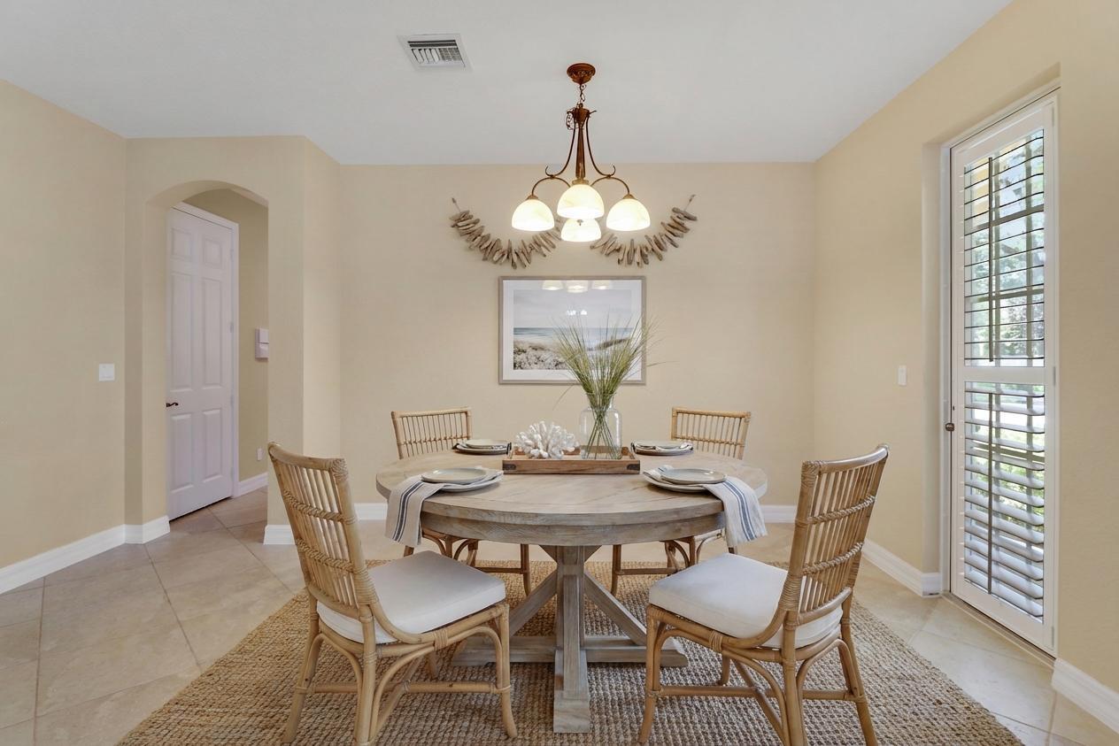 138 Tallow Trail Jupiter, FL 33458 - Photo 7 of 38 a view of a dining room with furniture and chandelier