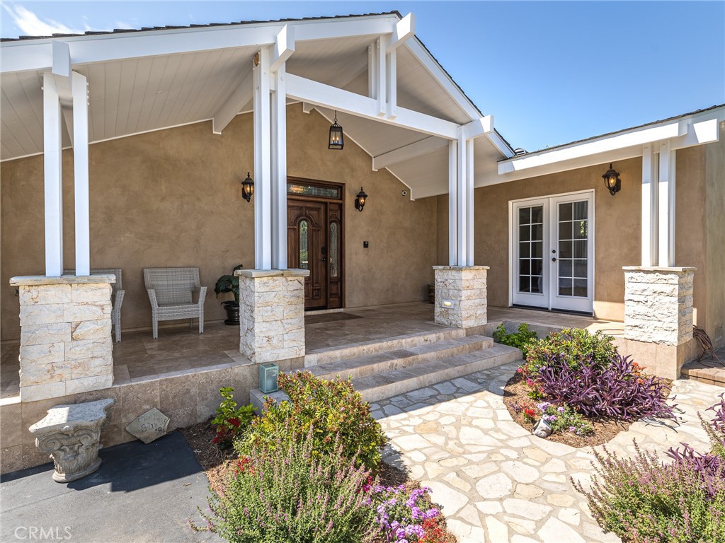 8 Stallion Road Rancho Palos Verdes, CA 90275 - Photo 2 of 56 a front view of a house with potted plants