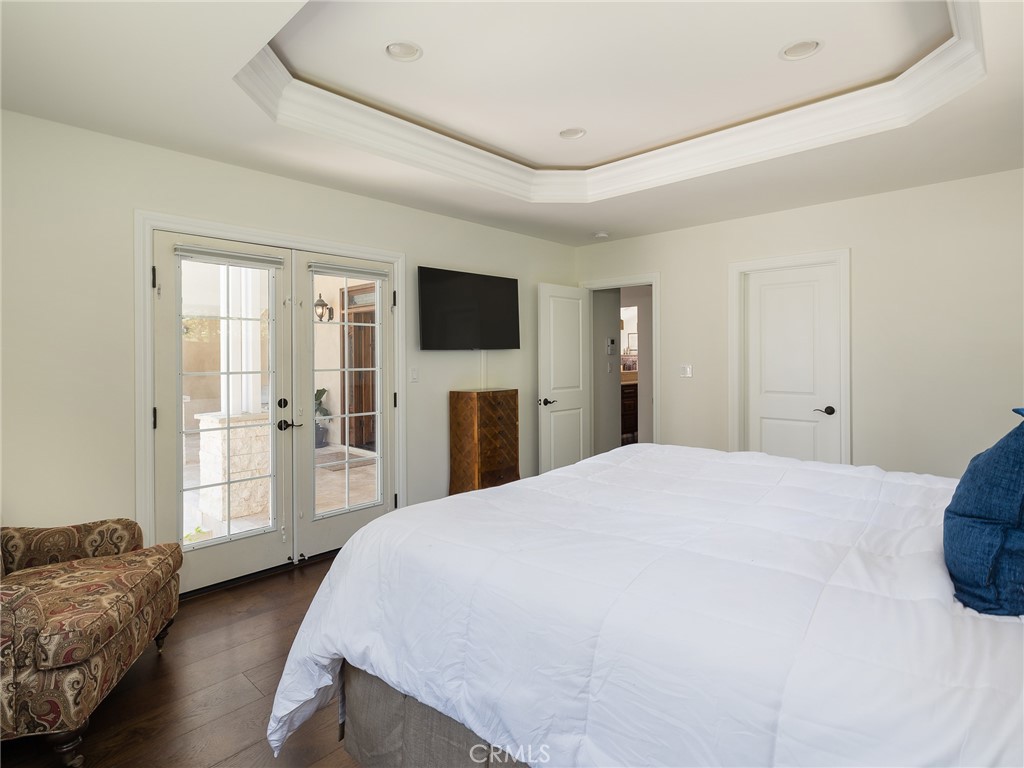 8 Stallion Road Rancho Palos Verdes, CA 90275 - Photo 22 of 56 a spacious bedroom with a bed and a flat screen tv