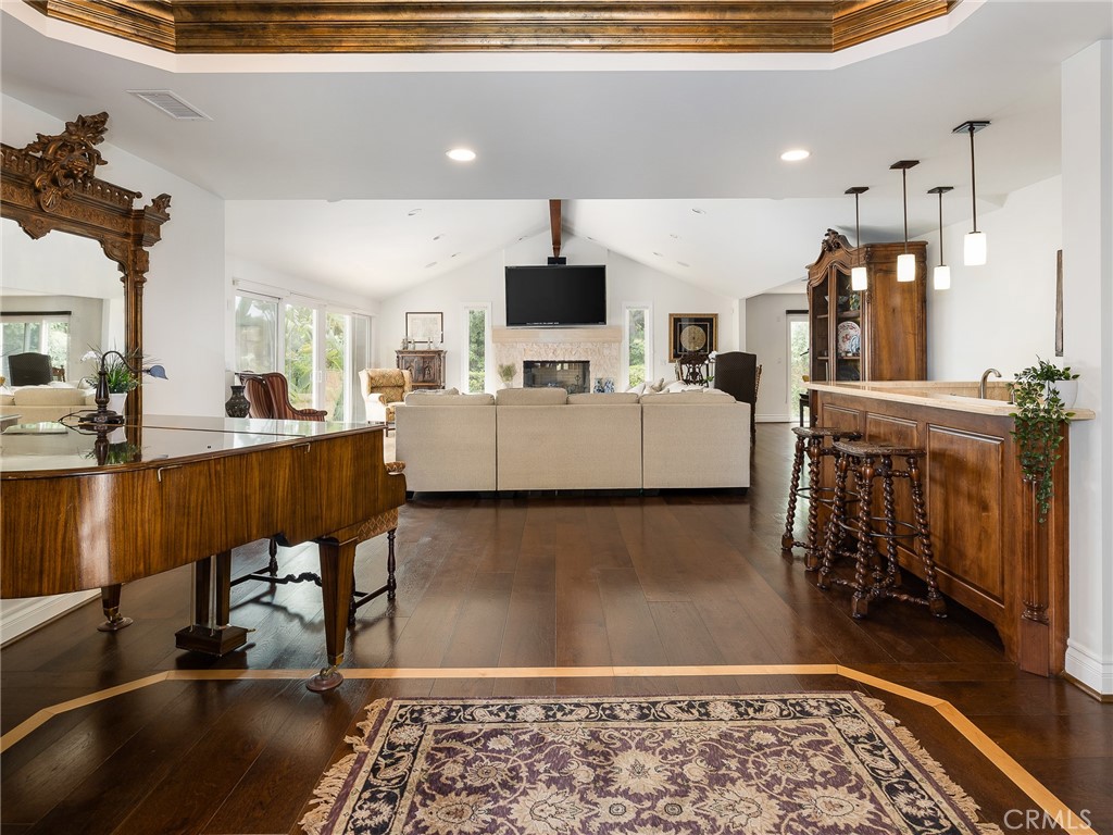 8 Stallion Road Rancho Palos Verdes, CA 90275 - Photo 4 of 56 a living room with a couch and a dining table with wooden floor
