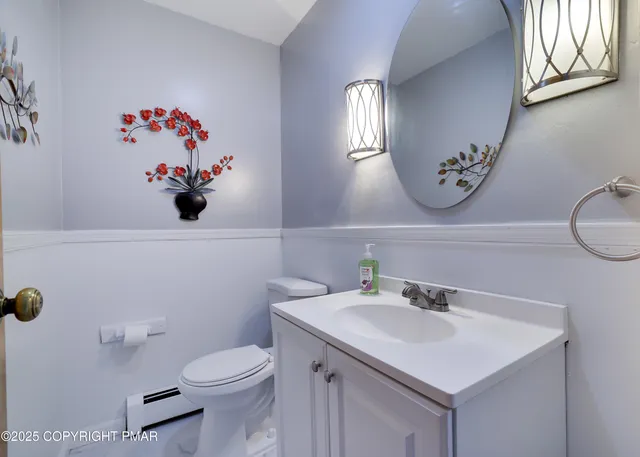 a bathroom with a sink mirror and toilet