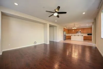 a view of a kitchen with a sink wooden cabinet and a refrigerator