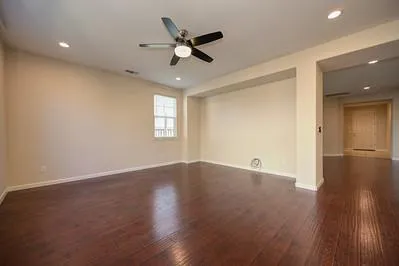a kitchen with kitchen island granite countertop wooden cabinets and white appliances