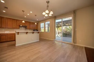 a kitchen with stainless steel appliances granite countertop a sink a stove a refrigerator and cabinets