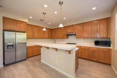 a kitchen with a sink cabinets and wooden floor