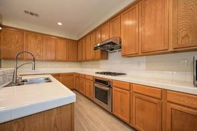 a kitchen with a sink and a stove top oven