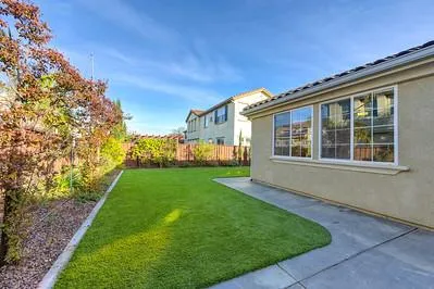 a view of house with backyard and garden