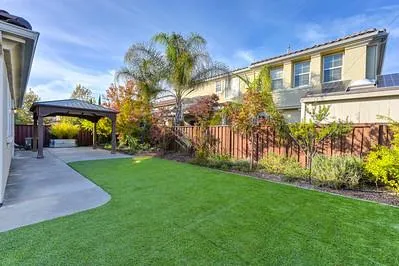 a view of a bench in back yard of the house