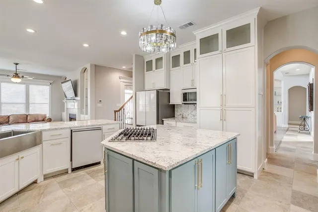a kitchen that has a lot of cabinets in it