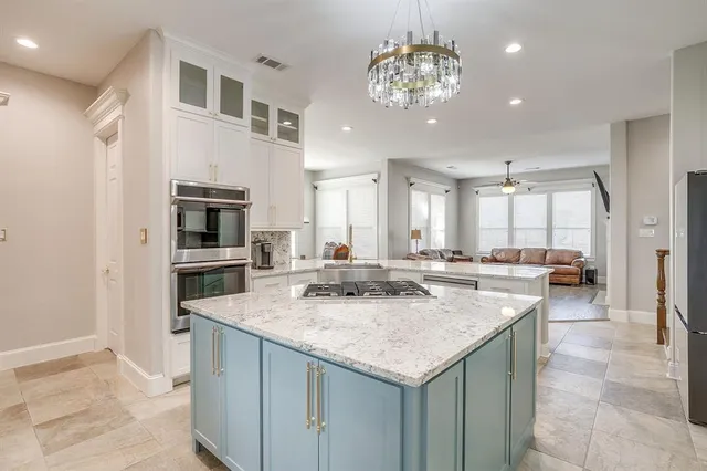 a kitchen with center island and stainless steel appliances