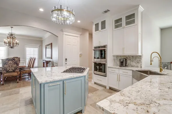 a view of living room kitchen island stainless steel appliances wooden floor and living room view