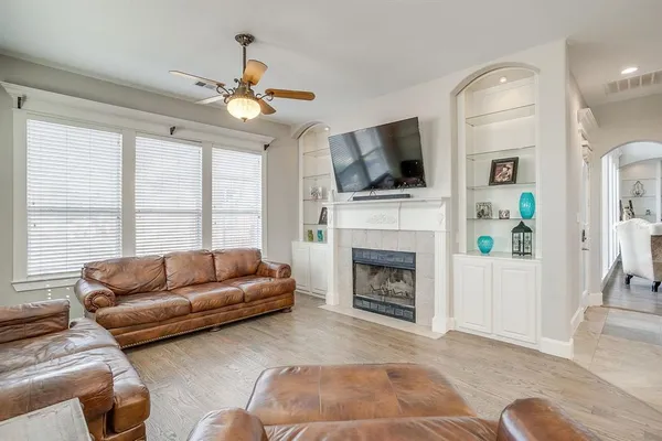 a living room with furniture a flat screen tv and a fireplace