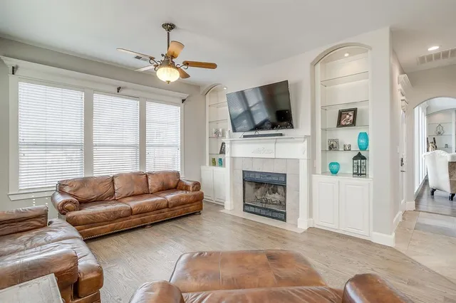 a living room with furniture a flat screen tv and a fireplace