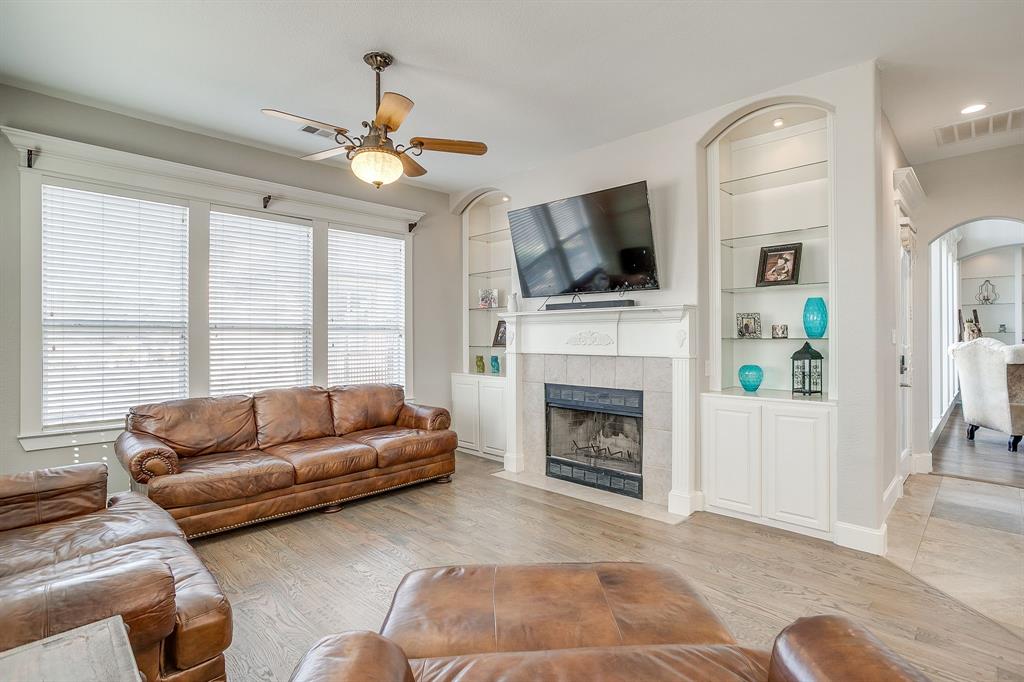 253 Bayne Road Haslet, TX 76052 - Photo 20 of 40 a living room with furniture a flat screen tv and a fireplace