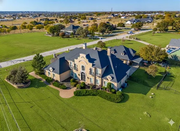 an aerial view of a house with outdoor space swimming pool and ocean view