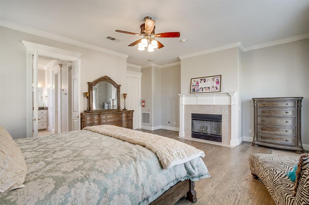 253 Bayne Road Haslet, TX 76052 - Photo 24 of 40 a bedroom with a bed and a fireplace