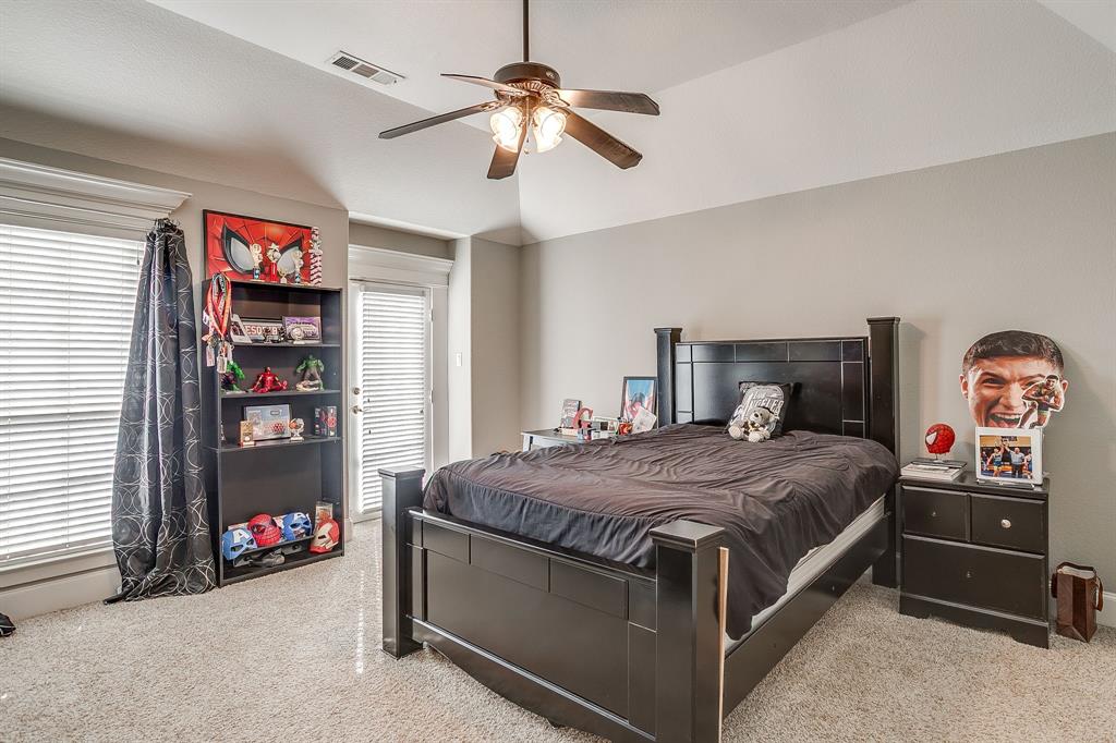 253 Bayne Road Haslet, TX 76052 - Photo 27 of 40 a bedroom with bed and a chandelier
