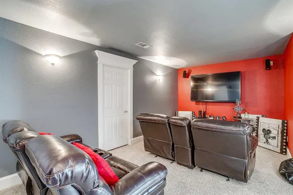 a room with furniture and a projector screen