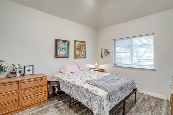 a bedroom with a bed and window